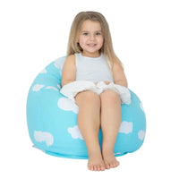 Child sitting on a blue bean bag with cloud pattern