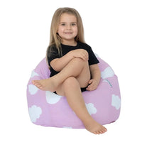 Child sitting on a pink bean bag with white cloud patterns