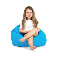 Young girl sitting on a blue bean bag chair against a white background