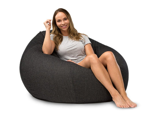 lady sitting on a charcoal denim bean bag