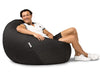 man sitting on a charcoal denim bean bag