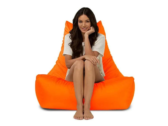Woman sitting on an orange bean bag chair against a white background